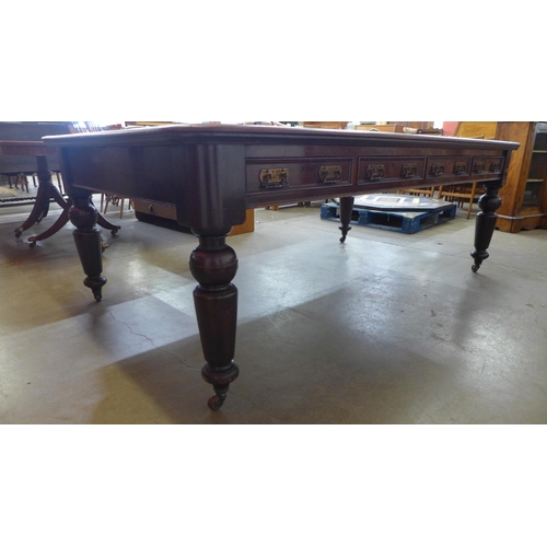 26 - A Victorian mahogany and brown leather topped double sided eight drawer library table, 76cms h, 214c... 