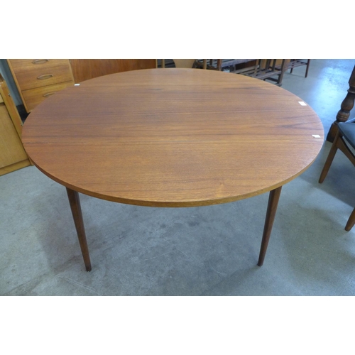 53 - A teak drop-leaf table and four chairs