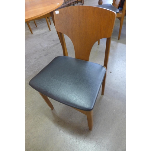 53 - A teak drop-leaf table and four chairs