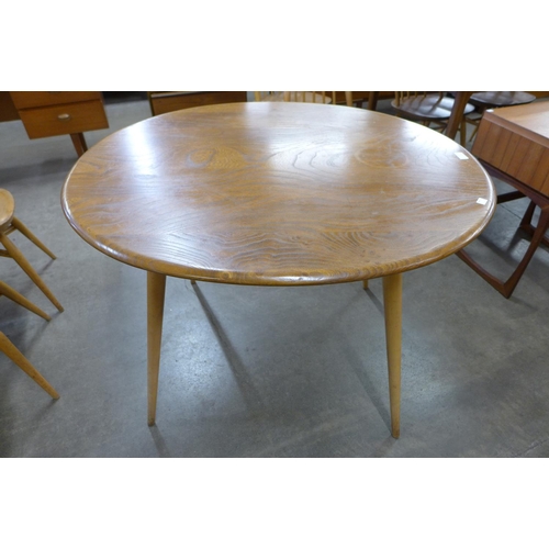 57 - An Ercol Blonde elm and beech oval Windsor breakfast table