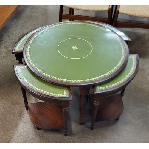 164A - A mahogany and green leather topped circular nest of tables