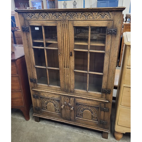 107 - A 17th Century style carved Ipswich oak four door bookcase