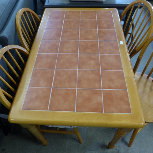 1590 - A beech kitchen dining table with tiled top and four dining chairs