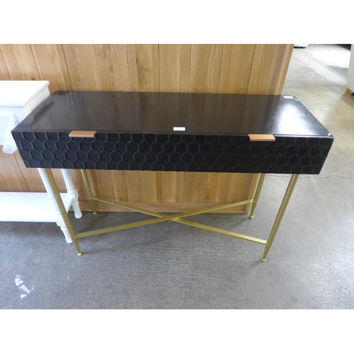 1604 - A black console table on gold legs, MARKED