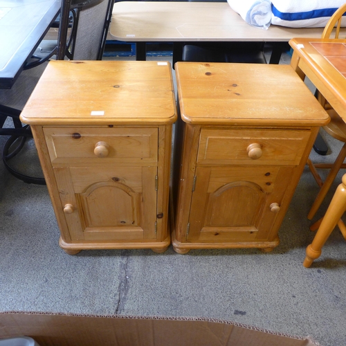 1596 - A pair of pine single drawer single door bedside cabinets