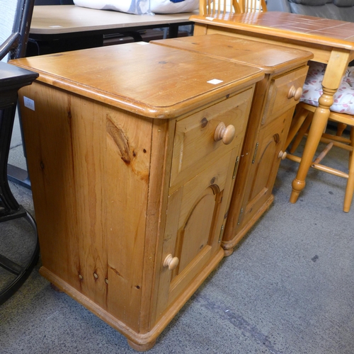 1596 - A pair of pine single drawer single door bedside cabinets