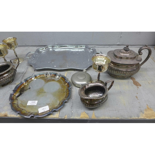 1122 - A collection of plated ware including trays, goblets, a three piece tea service and a pewter hip fla... 