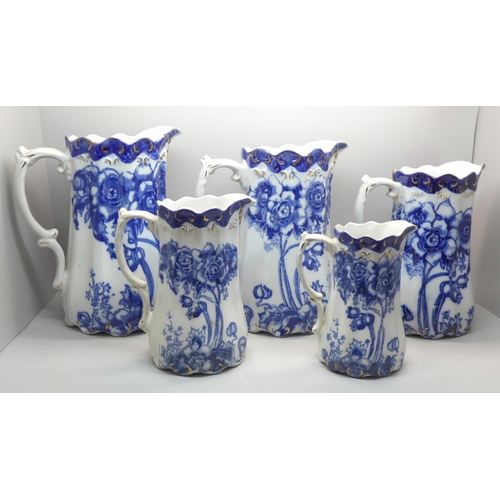 602 - A set of five graduated Doulton Burslem blue and white jugs