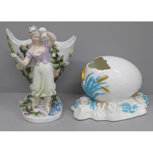 607 - A German porcelain figural spill holder and egg ornament, both a/f