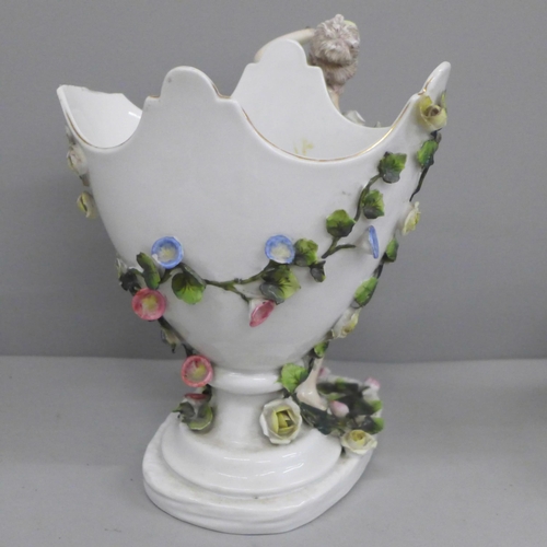 607 - A German porcelain figural spill holder and egg ornament, both a/f