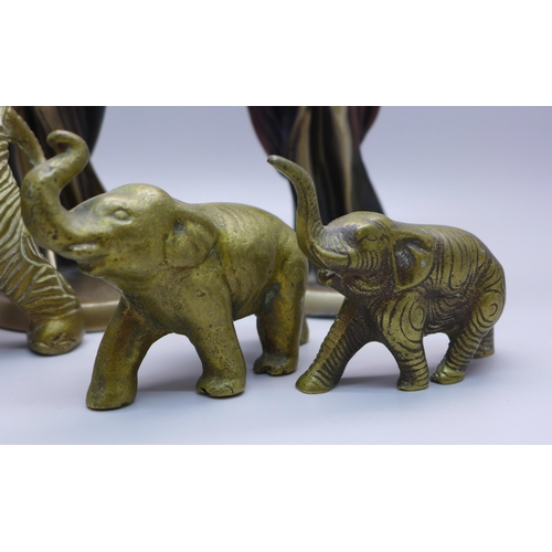 608 - Two Art Deco style figures of ladies and three brass elephant figures