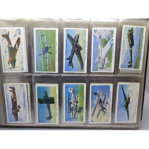 616 - Cigarette cards; an album of military themed cigarette and trade cards, (11) complete sets including... 