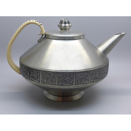 623 - A Norwegian Savo pewter teapot with cane bound handle