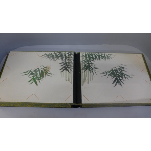 642 - An oriental photograph album with lacquered cover