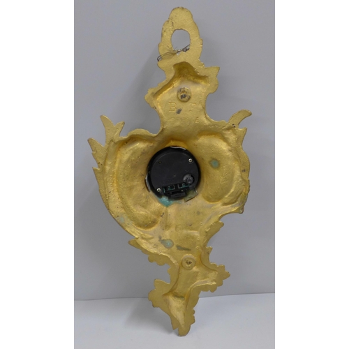 762 - A heavy cast brass wall timepiece, 34cm