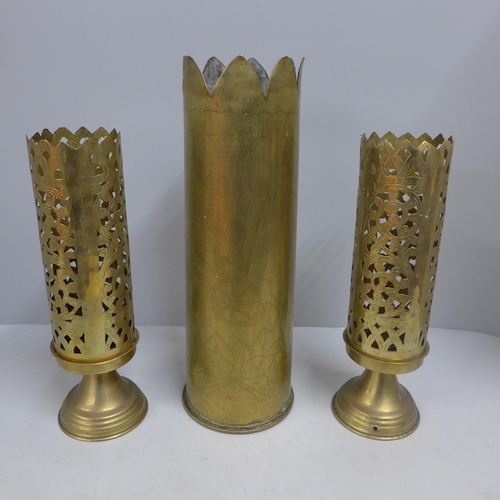 763 - A trench art shell case vase and two brass vases