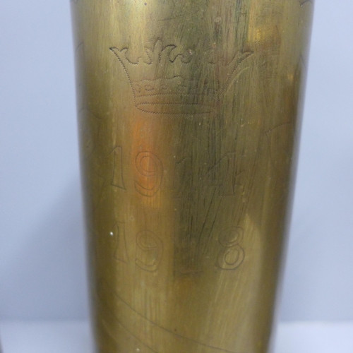 763 - A trench art shell case vase and two brass vases