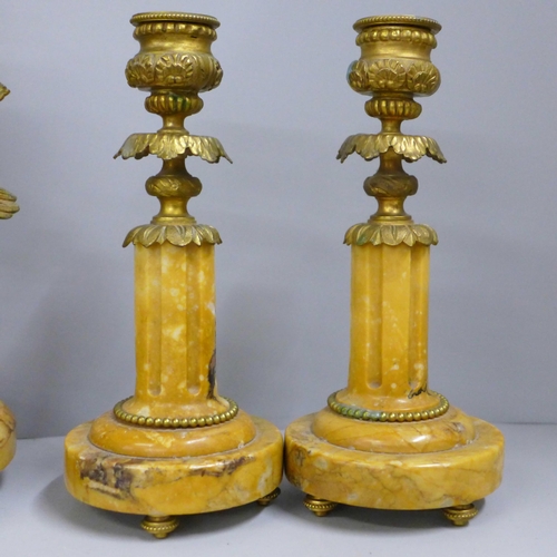 764 - A 19th Century French yellow marble and gilt metal clock garniture, with cupid, the porcelain dial m... 