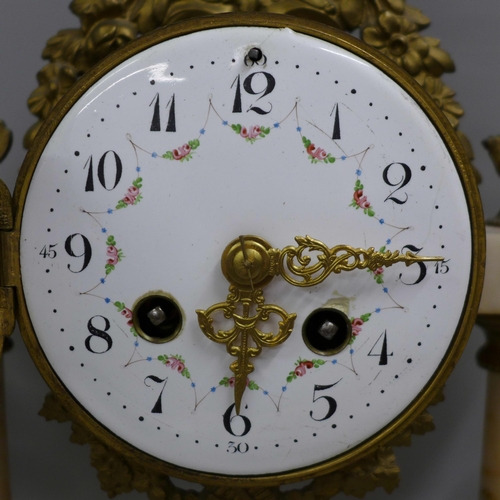 765 - A French white marble and gilt metal clock garniture with porcelain dial, 38cm