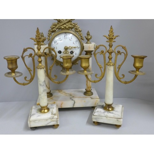 765 - A French white marble and gilt metal clock garniture with porcelain dial, 38cm