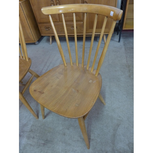 10 - A pair of Ercol Blonde elm and beech 449A model cow horn chairs and another pair of Ercol chairs