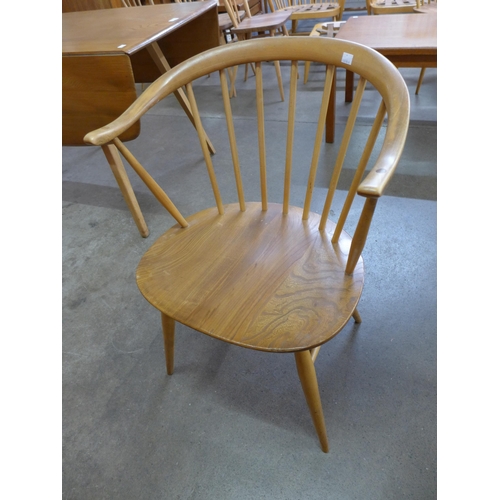 10 - A pair of Ercol Blonde elm and beech 449A model cow horn chairs and another pair of Ercol chairs