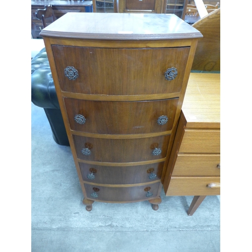 106 - A walnut bow front chest of drawers