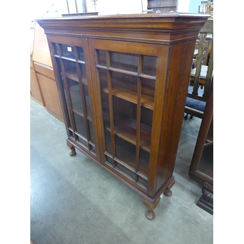 108 - An Edward VII oak and astragal glazed two door bookcase