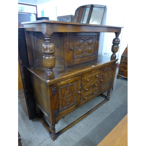 120 - A 17th Century style carved oak court cupboard