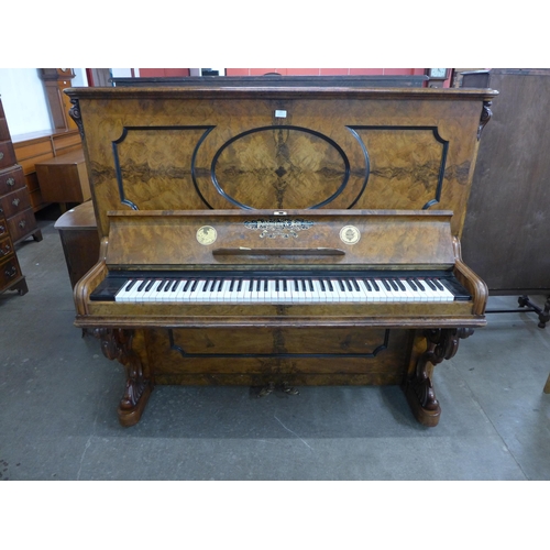 122 - A Victorian burr walnut Pohlmann & Son, Patent Escapement Action overstrung upright piano. With non-... 