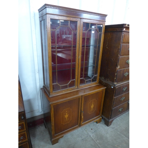 124 - A Regency style inlaid mahogany side cabinet