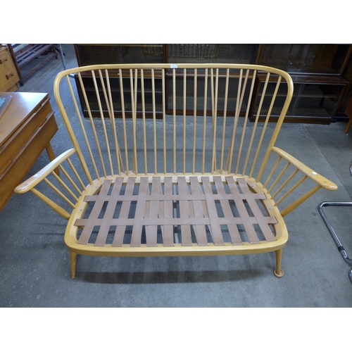 15 - An Ercol Blonde beech four piece Windsor lounge suite, comprising a settee, pair of armchairs and fo... 