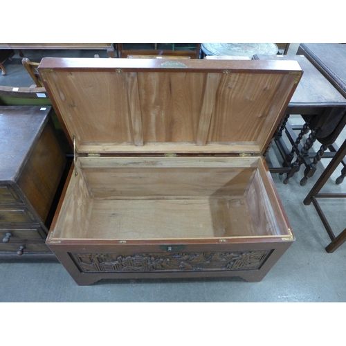 156 - An oriental carved camphorwood blanket box