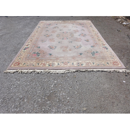 197 - A large Chinese pink ground rug 385cm x 268cm