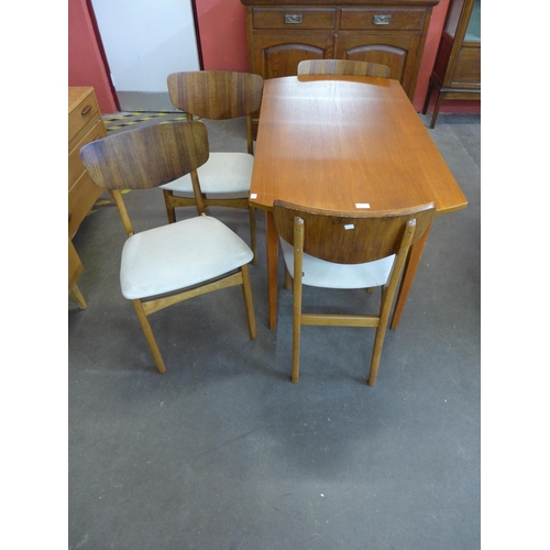 56 - A teak dining table and four chairs