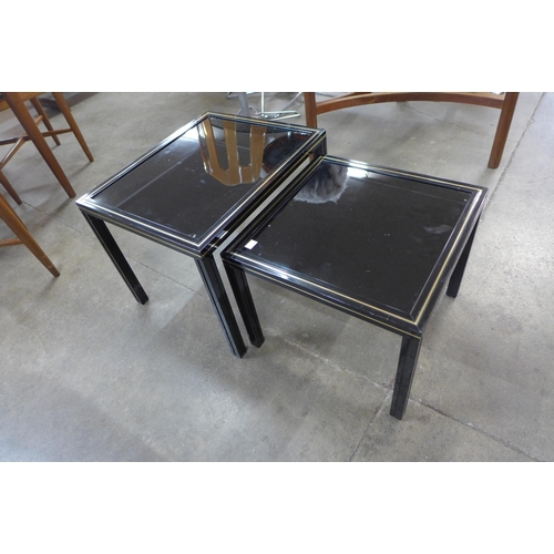 75A - A Pierre Vandel of Paris black lacquered metal and glass topped nest of two tables