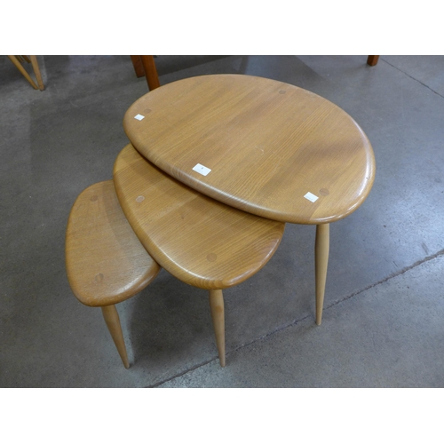 8 - An Ercol Blonde elm and beech pebble shaped nest of tables