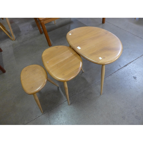 8 - An Ercol Blonde elm and beech pebble shaped nest of tables