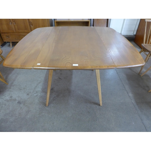 9 - An Ercol Blonde elm and beech  Windsor drop leaf table