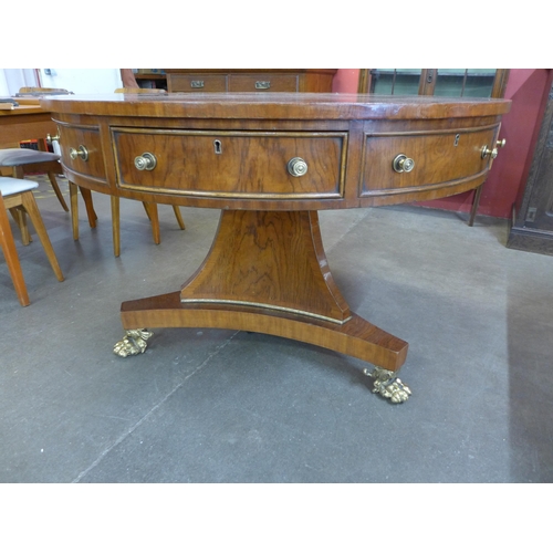 93 - A Regency style simulated rosewood drum shaped four drawer library table