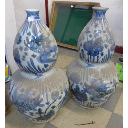 300 - A pair of Chinese blue and white stoneware double gourd shaped vases