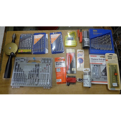 2090 - A brace drill and an assortment of unused bit sets