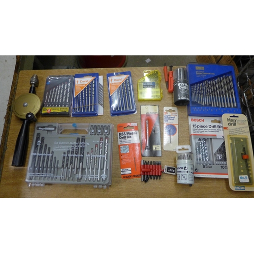 2090 - A brace drill and an assortment of unused bit sets