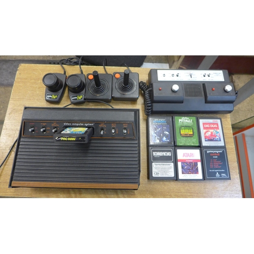 2155 - An original Artari console 2600 Woody including cables, joysticks, pedals, and games including Pacma... 