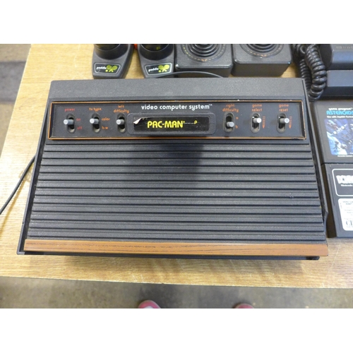 2155 - An original Artari console 2600 Woody including cables, joysticks, pedals, and games including Pacma... 