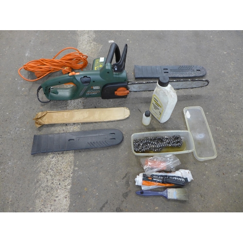 2286 - A Black & decker chainsaw with spare blade, tools and oil (model GK11640T)