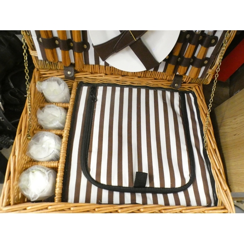 2506 - An as new picnic basket set including knives, forks, spoons, bottle opener, drinking glasses, and a ... 