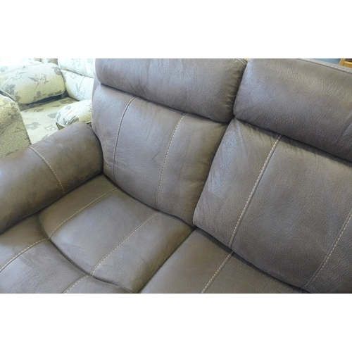 1571 - A brown upholstered two seater reclining sofa