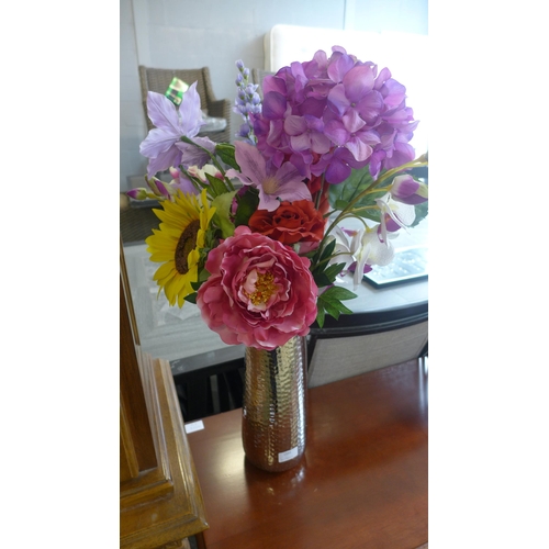 1593 - An arrangement of flowers in tall silver vase