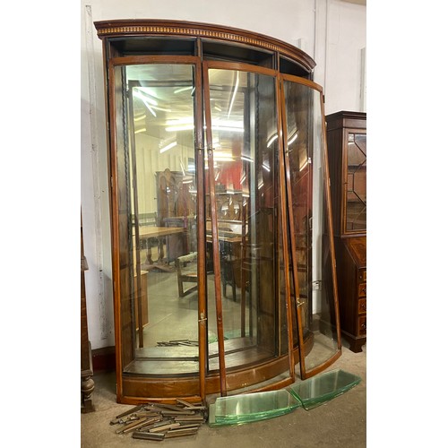 215 - A large mahogany three door corner bow front shop cabinet, 240cms h, 177cms w, 39cms d